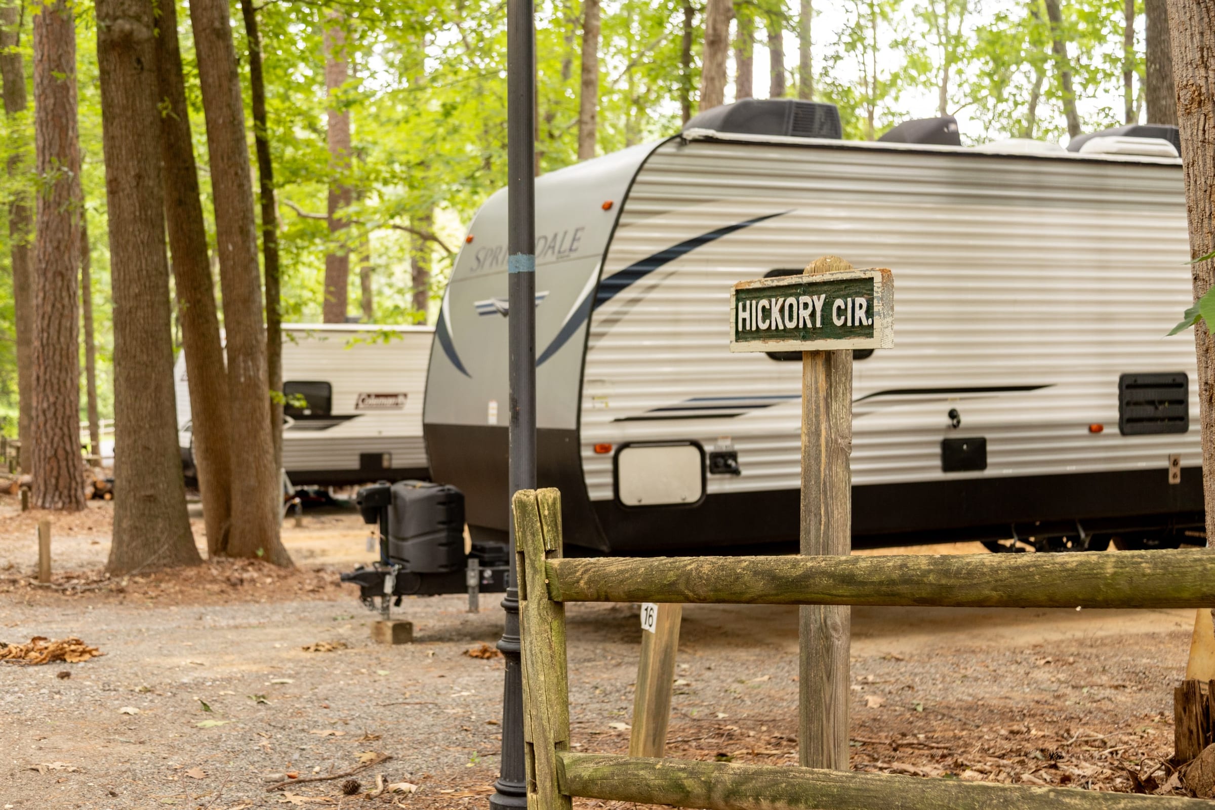 Travel trailer parked behind the Hickory Cir. lamppost sign