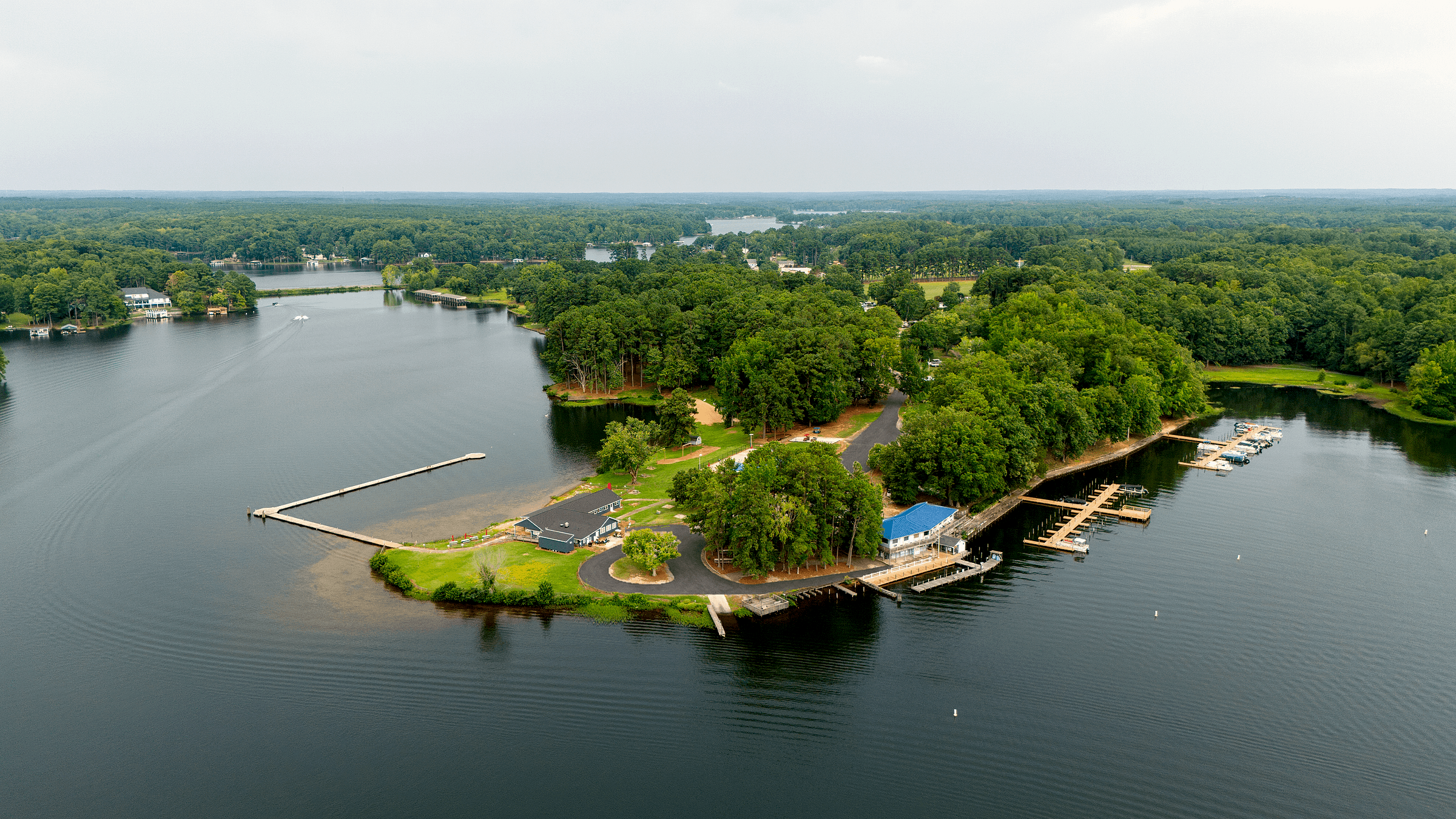 Retouched aerial of the marina island: store, slips and boat lifts among the trees