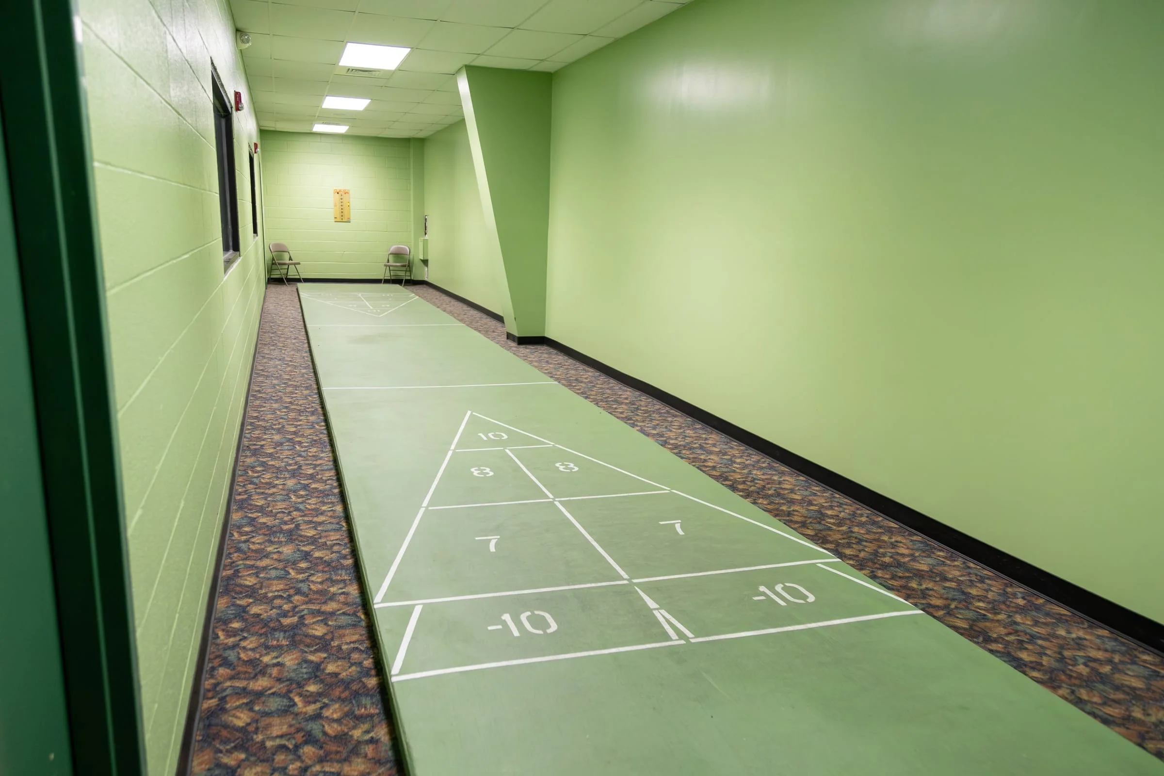 Indoor shuffleboard courts in the green games room