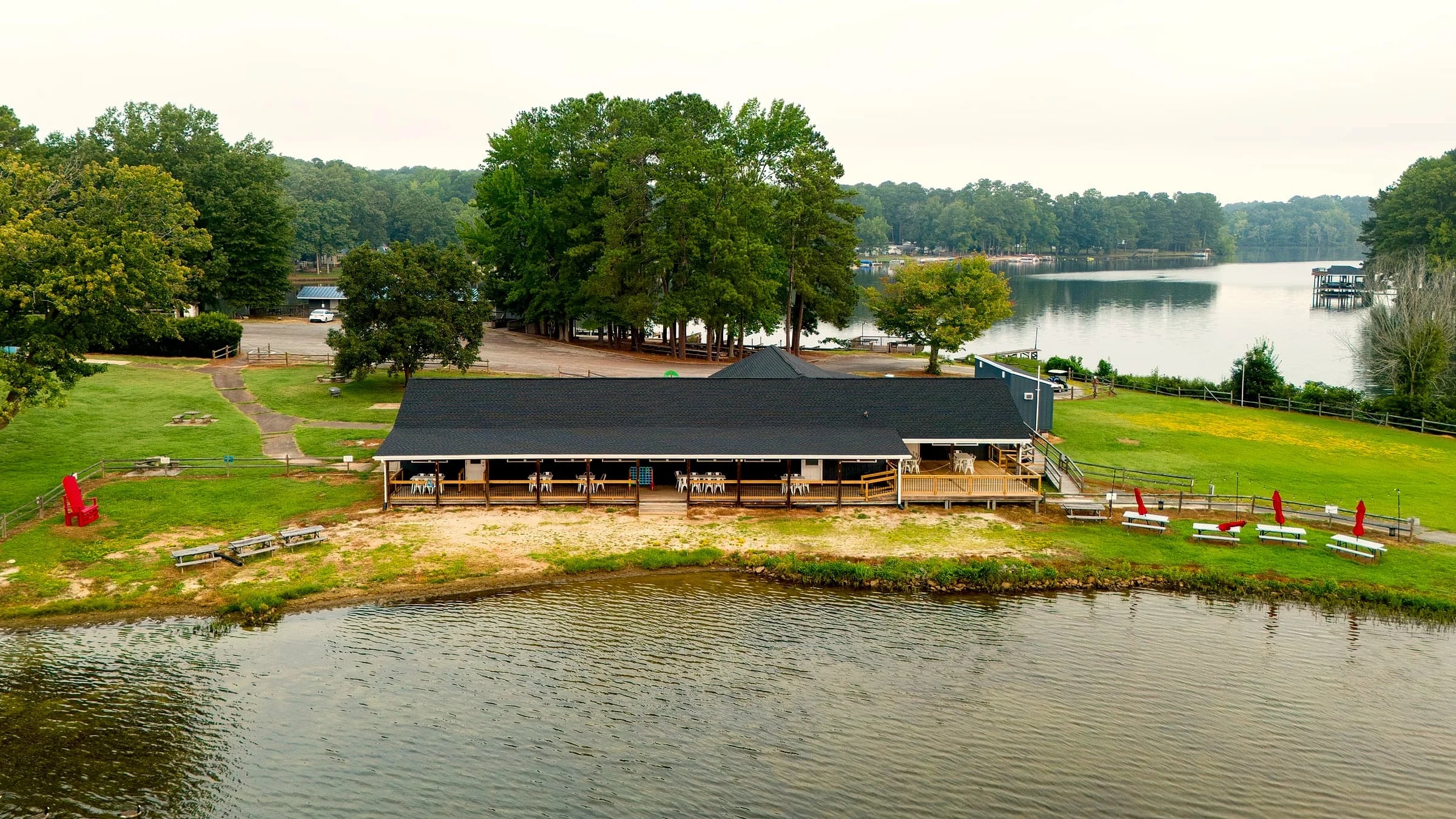 Low aerial of the Latitudes building along the waterline, umbrellas on the deck